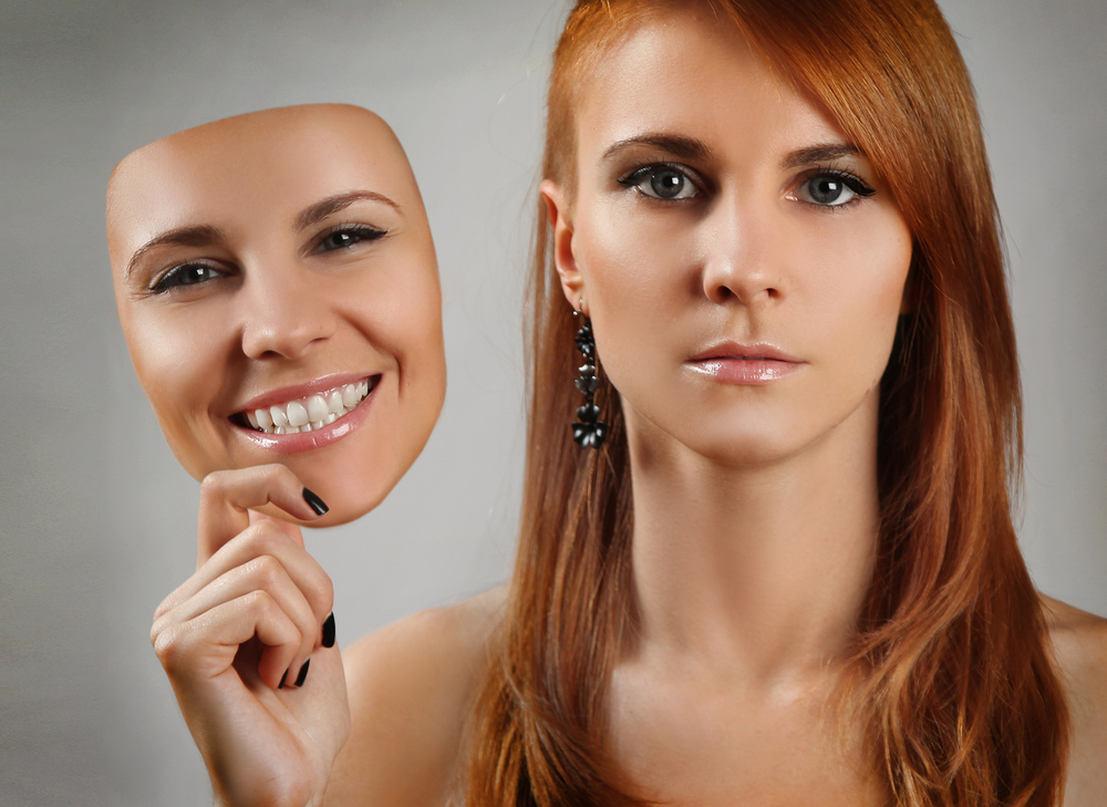 Woman Holding Realistic Mask Next to Face