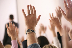 Room Full of Raised Hands