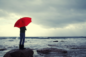 Person Standing on Rock at the Seashore